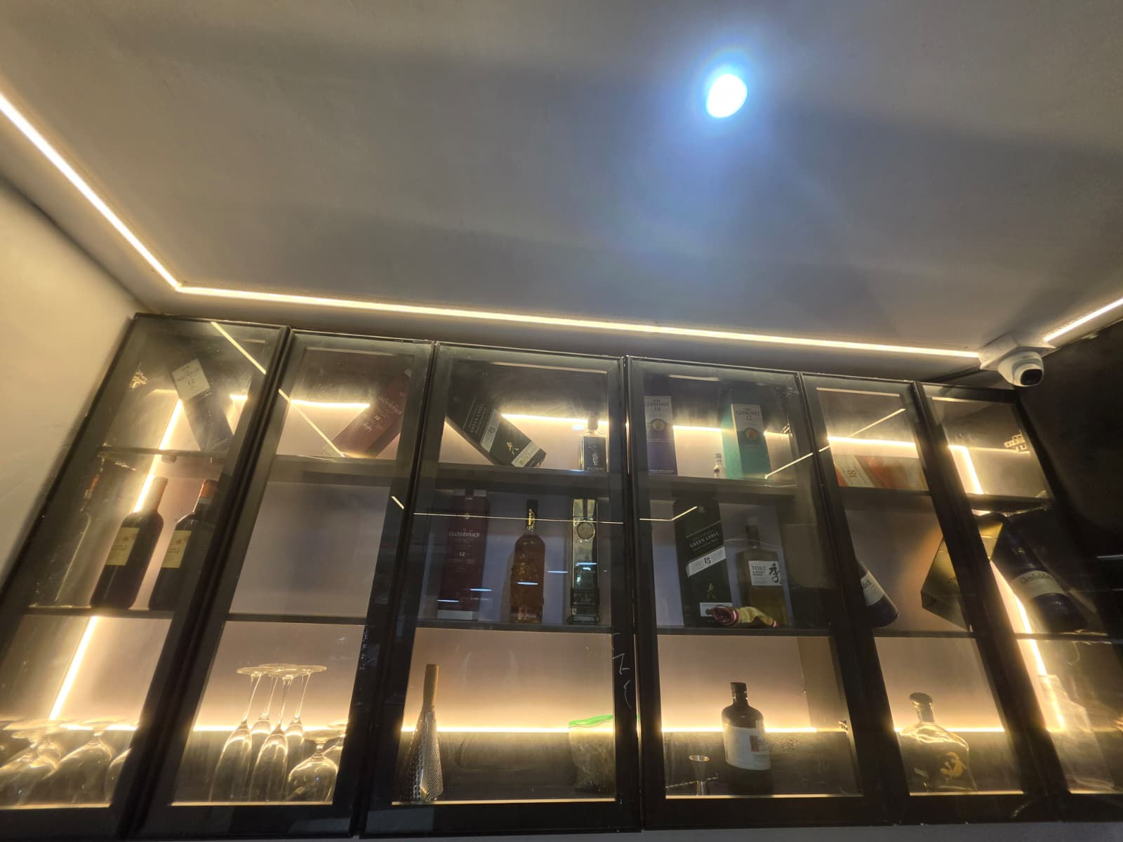 Warmly lit lounge seating and backlit spirits display at LAWRENCE LIZ VILLE, a hotel in Ibeju-Lekki, Lagos